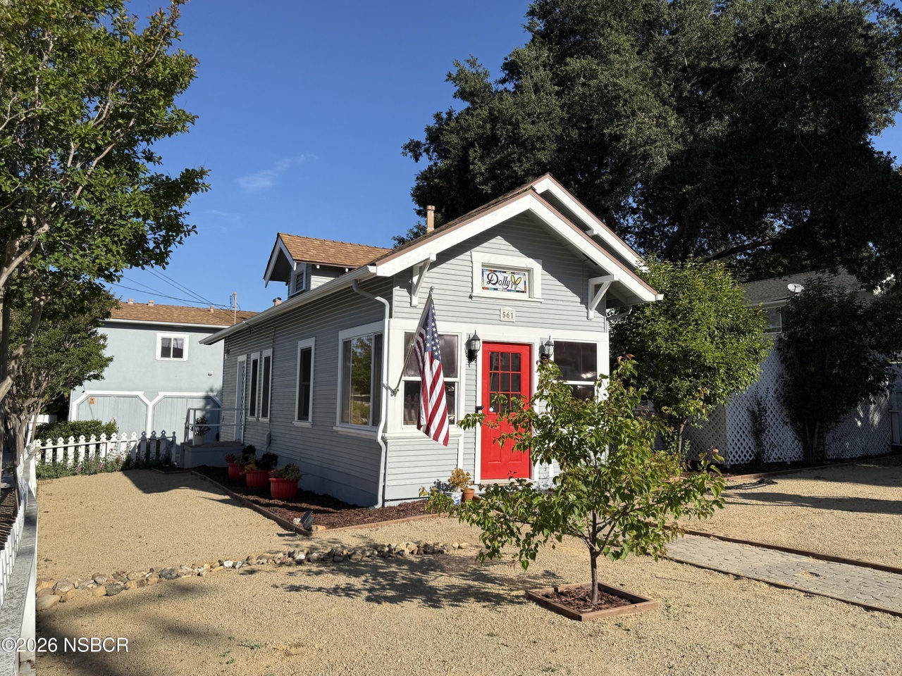Front of 561 Alisal Rd, a 1920 cottage in downtown Solvang with a red door